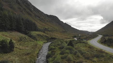 mountain pass with valley and bandy river and road next to it