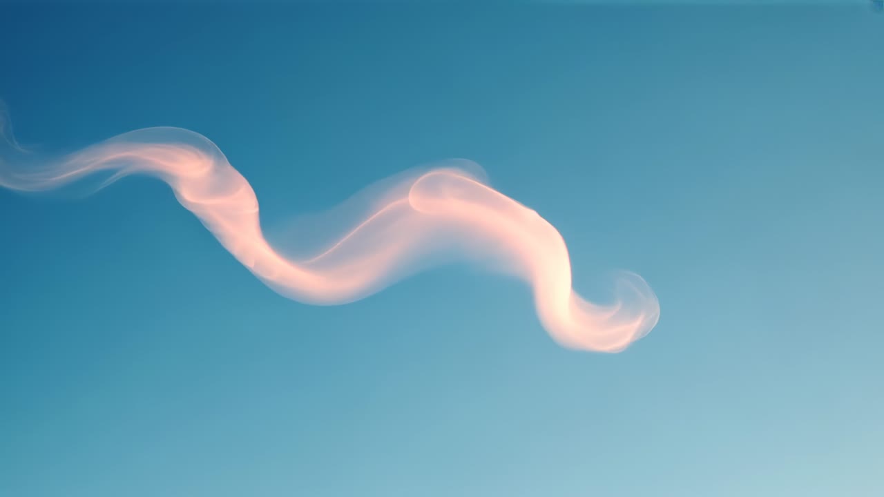 Drifting in clear blue sky under warm sun and light breeze, pink plume splitting into two