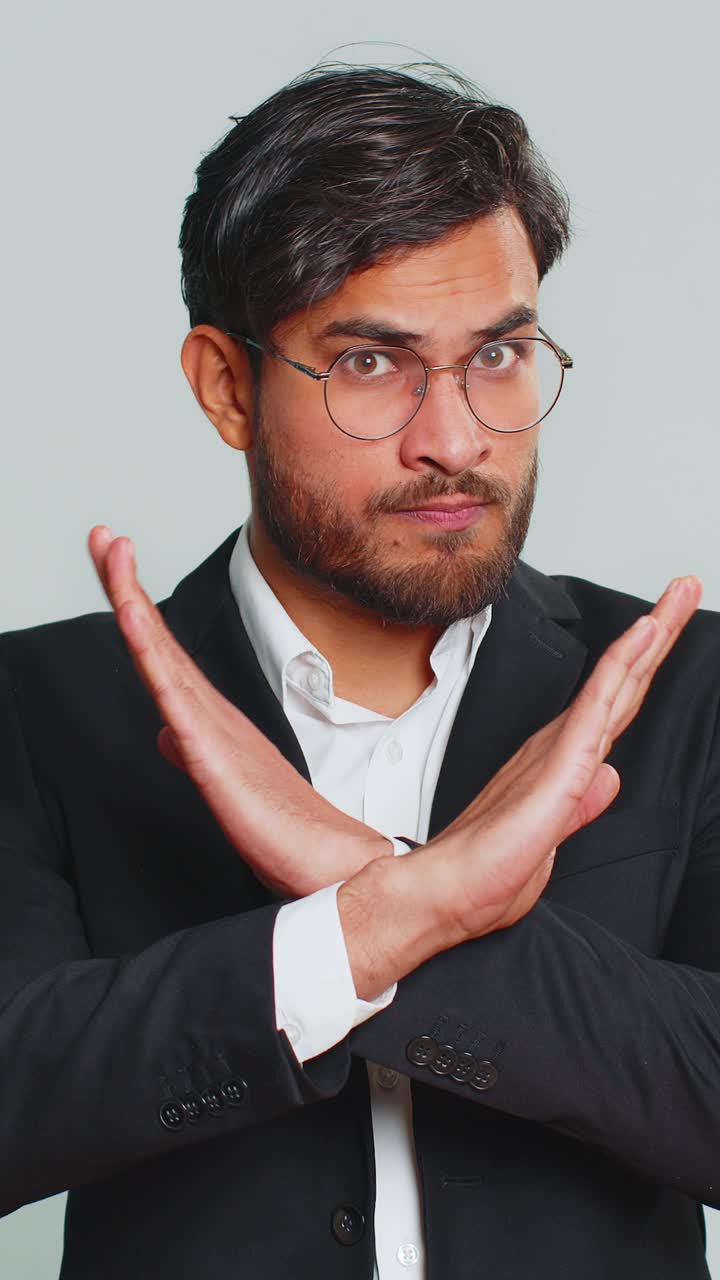 Businessman say no hold palm folded crossed hands in stop gesture warning finish prohibited access