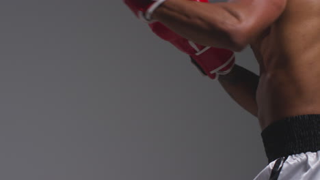 Close-Up-Studio-Shot-Of-Two-Male-Boxers-Wearing-Gloves-Fighting-In-Boxing-Match-Against-Grey-Background-15