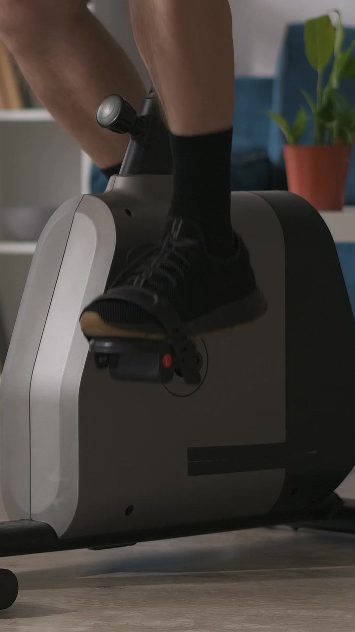 Close-up of Feet Pedaling an Exercise Bike Indoors