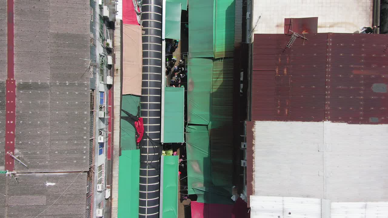 Ngau Chi Wan wet market rooftops, downtown Hong Kong with fresh Meat and Fish stalls, Top down aerial pass