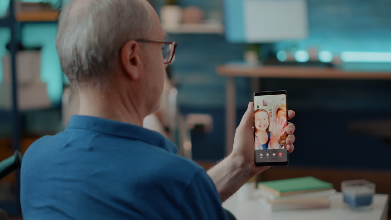 Senior man on a video call with family using a smartphone