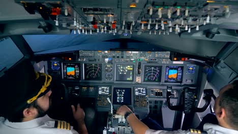 pilots sit in a flight simuator, close up.