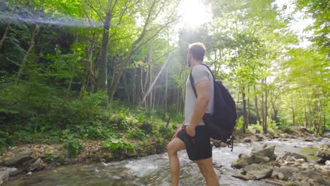 the free man watches the forest. a stream flows next to it.