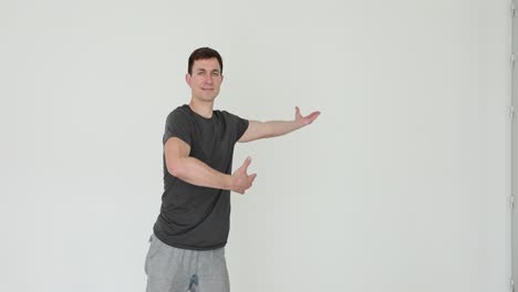 Man in Gray T-shirt with Arms Outstretched