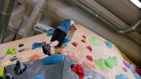 teenage boy bouldering indoors