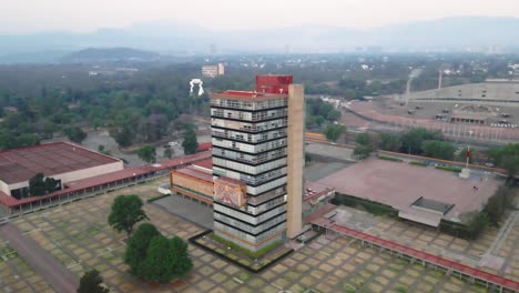 orbiting aerial view of an academic tower at ciudad universitaria, mexico city