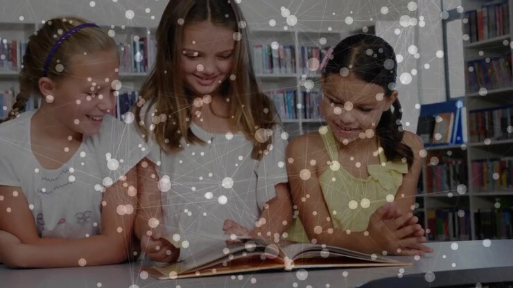 Two children leaning over picture book in library peer entering and flipping pages exploring story