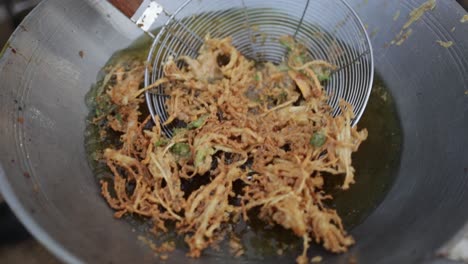 cooking deep fried enoki mushroom or golden needle mushroom in boiling hot oil