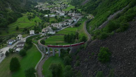 the bernina express ttrain passes over the helical brusio viaduct