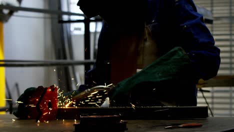 female welder using blowing torch on a rod 4k