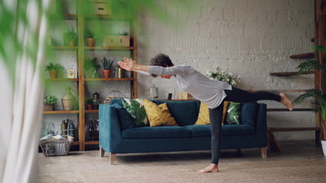 woman practicing yoga poses in living room