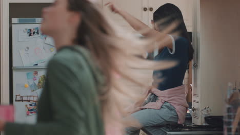 happy group of teenage girls dancing in kitchen having fun celebrating together enjoying hanging out together on party weekend