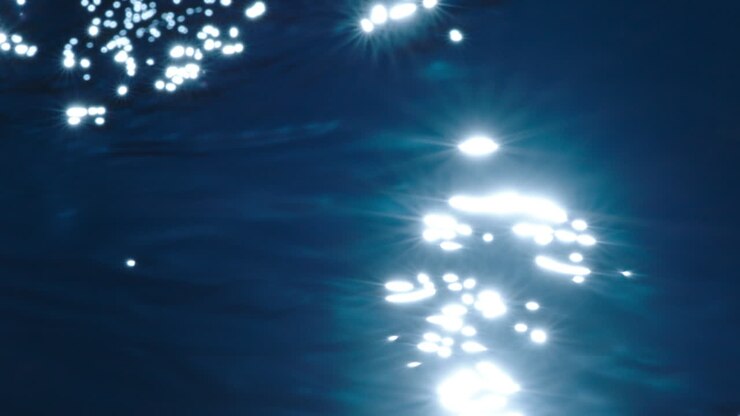 Fuori fuoco, acqua azzurra con piccole onde e increspature al rallentatore