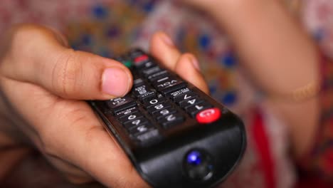 person using a tv remote