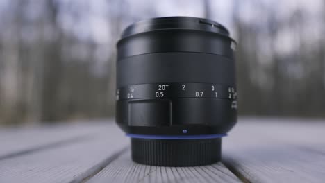 closeup of a camera lens on a wooden table