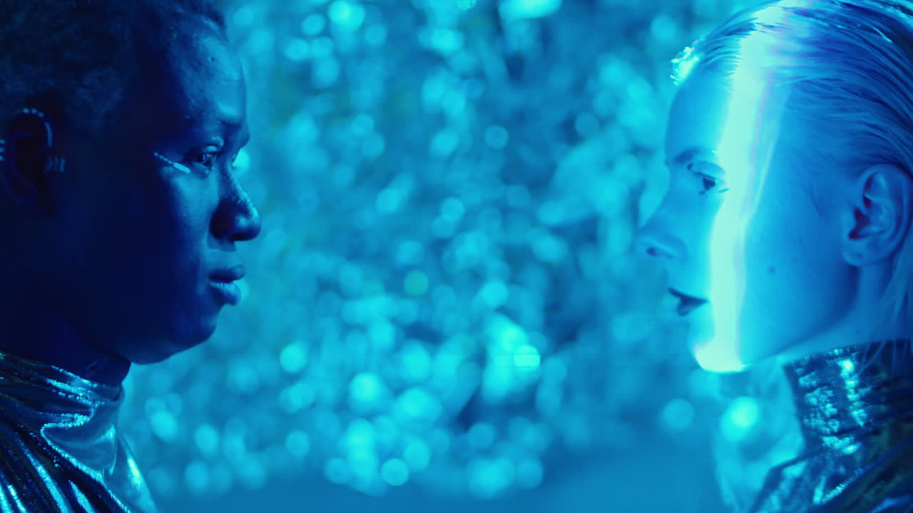 Side View of Male and Female Aliens in Blue Laser Light