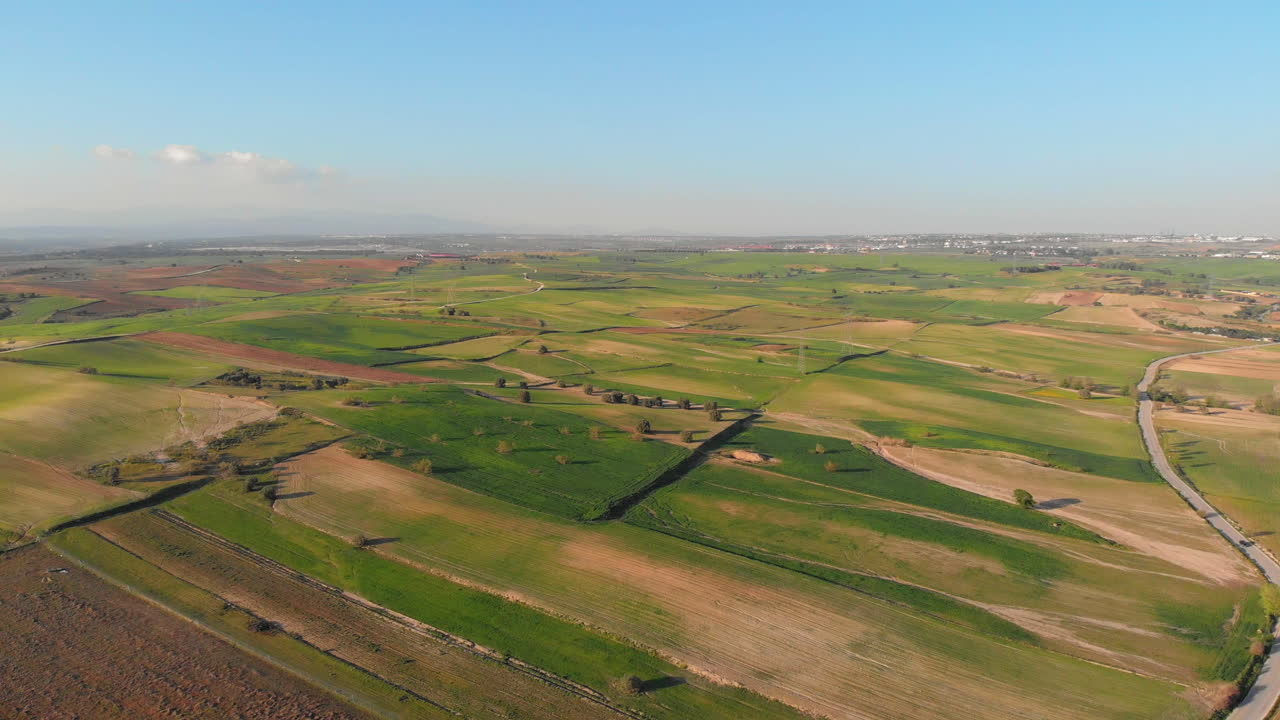 Aerial shot of a farm in a beautiful countryside on a sunny day