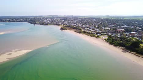 aerial footage over the ocean approaching the town of inverloch, victoria, australia