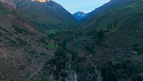 dolly in establishing aerial view of the yerba loca estuary at sunrise with soft light and solitude in a natural environment of the andes mountains, chile.