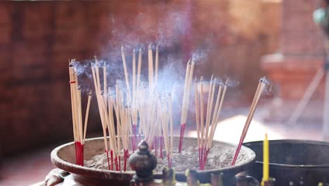 time-lapse of incense sticks burning and smoking