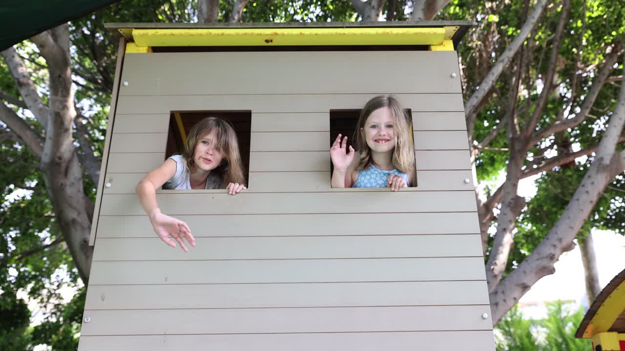 Two Young Girls Playing in a Playhouse