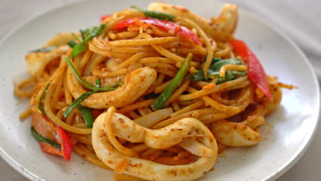 stir-fried spaghetti with salted egg and squid - fusion food style