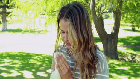 Woman-blowing-nose-with-tissue-paper