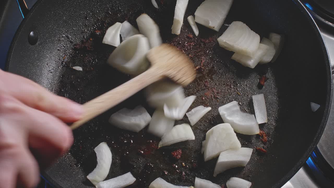 Sauteing Chopped Onions In Used Pan With Cooking Oil