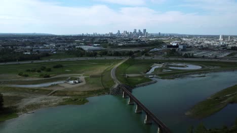 drone footage revealing downtown cityscape, industrial area, and highway, calgary, alberta, canada