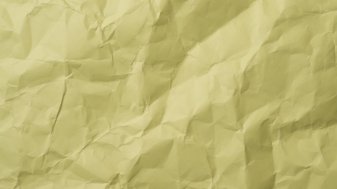Rough yellow sheet with torn edges in stop motion. Wrinkled paper texture with rustic vibes for retro, grunge, or design projects.