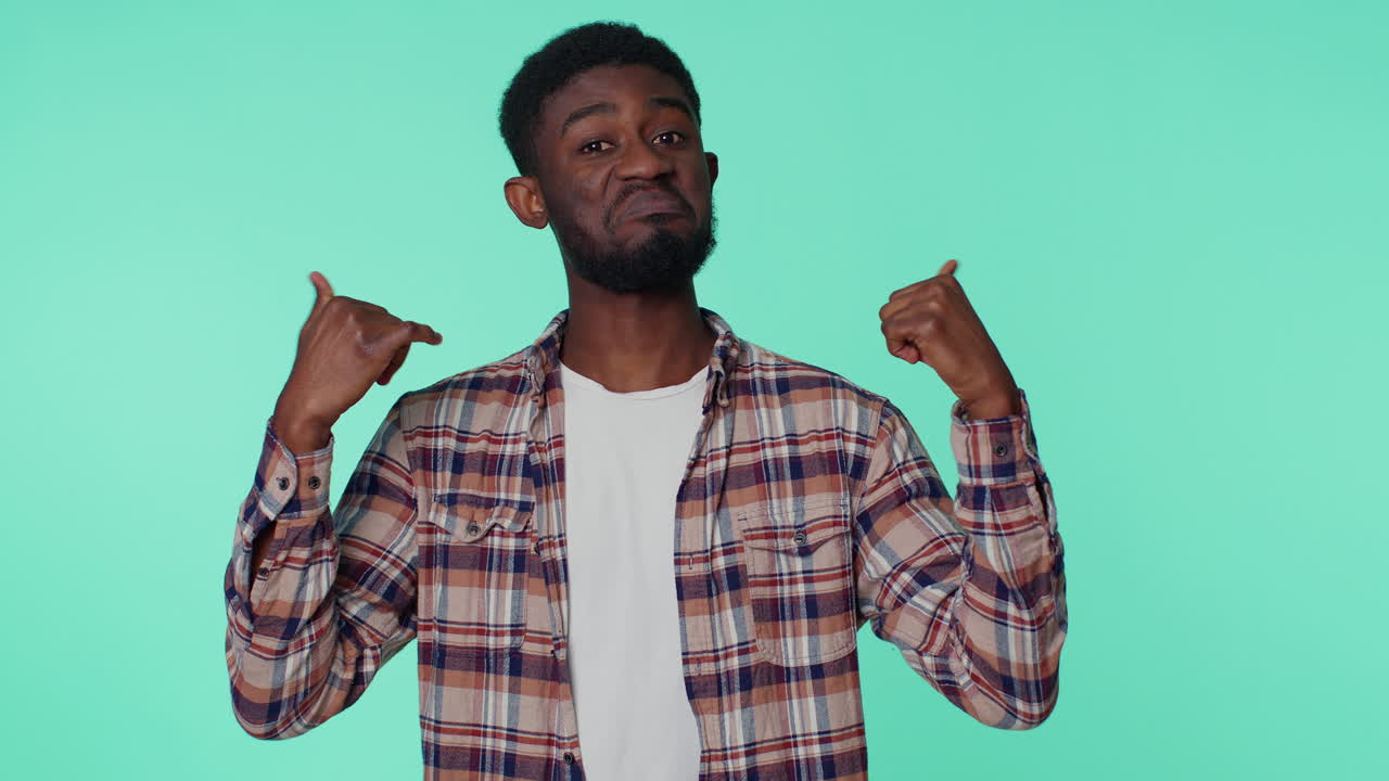 African american man feeling very proud pointing himself looking self-confident overjoyed by success