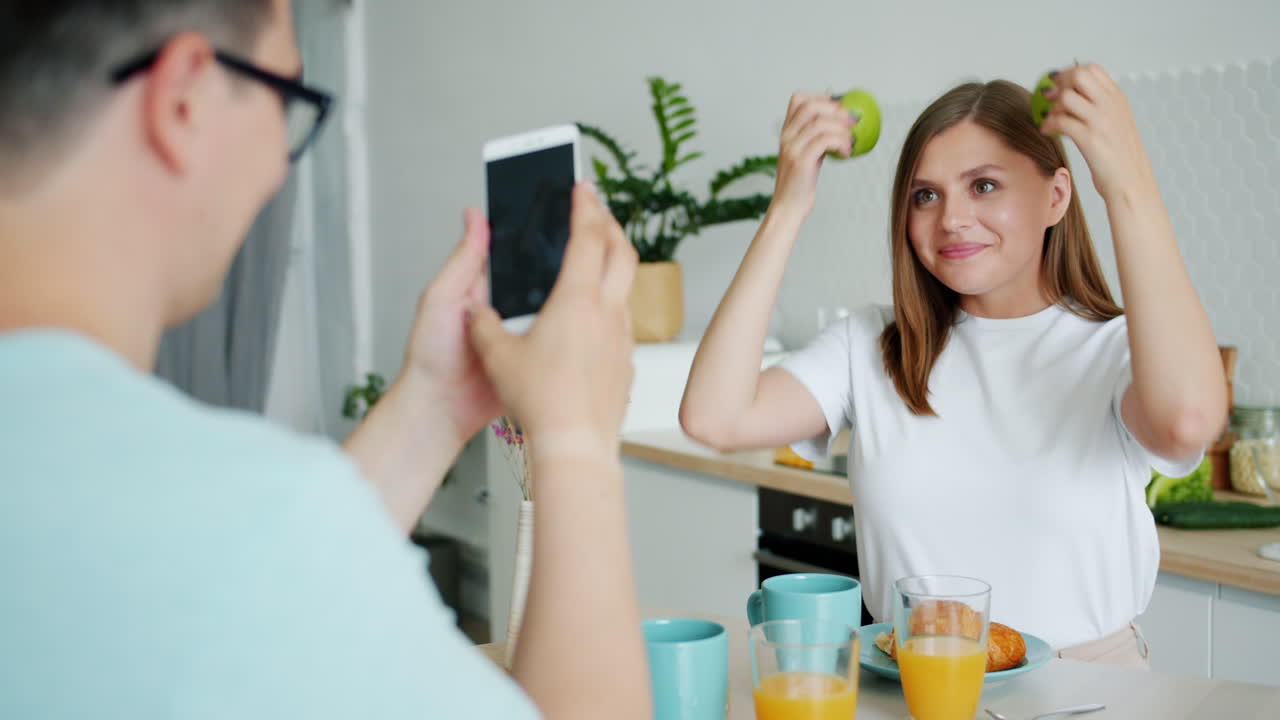 Couple having breakfast and taking pictures