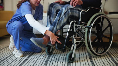 nurse assisting patient in wheelchair