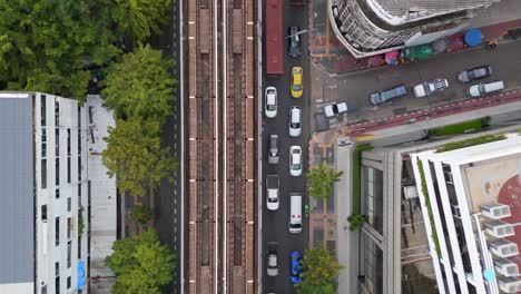 in flow of traffic next to elevated railroad line