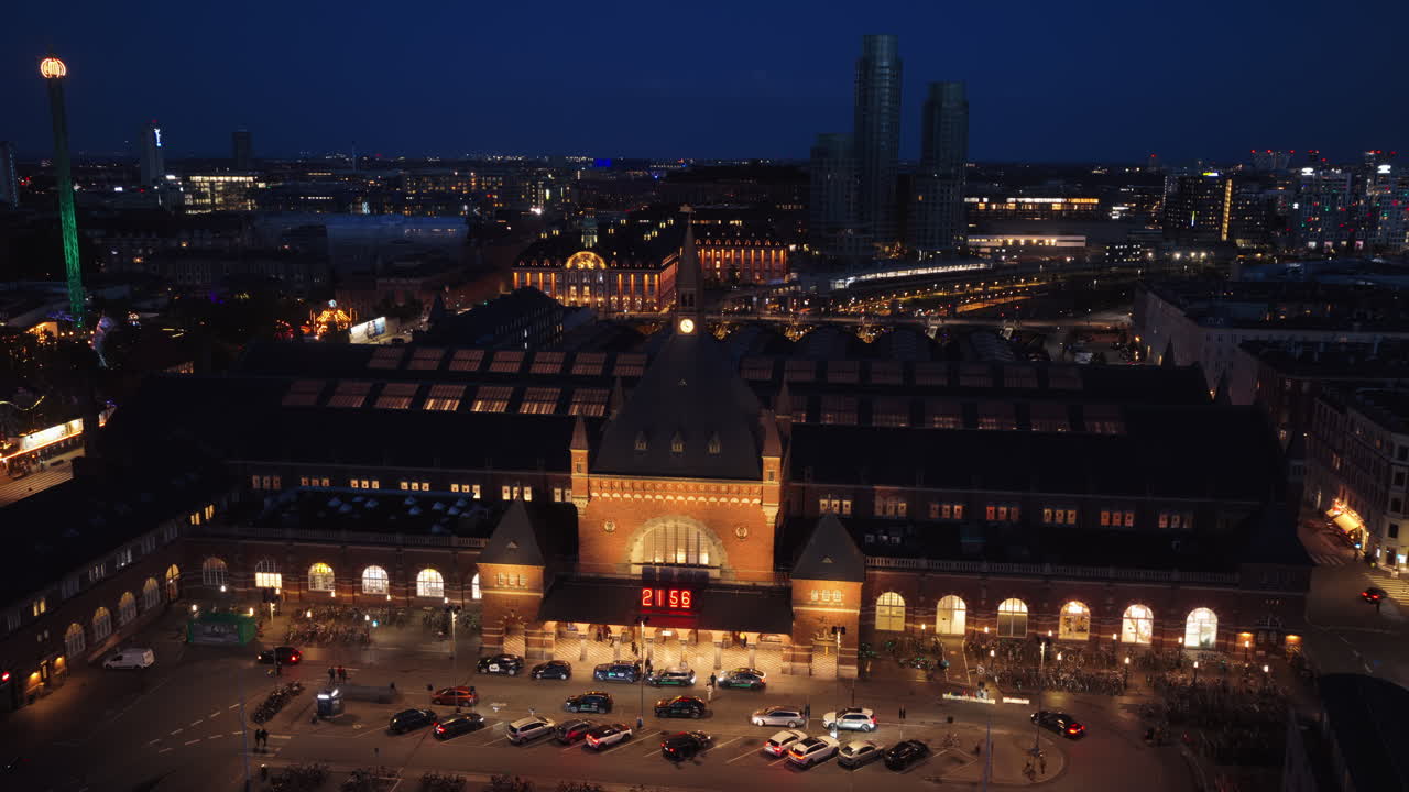 Aerial drone view of the Copenhagen Central Station front view at night with lights in Denmark