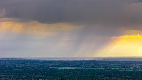 dark clouds moving against sunset horizon in rural nature. timelapse
