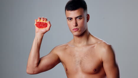 man squeezing grapefruit