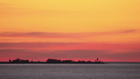 stunning sunset over the ocean with a lighthouse silhouette