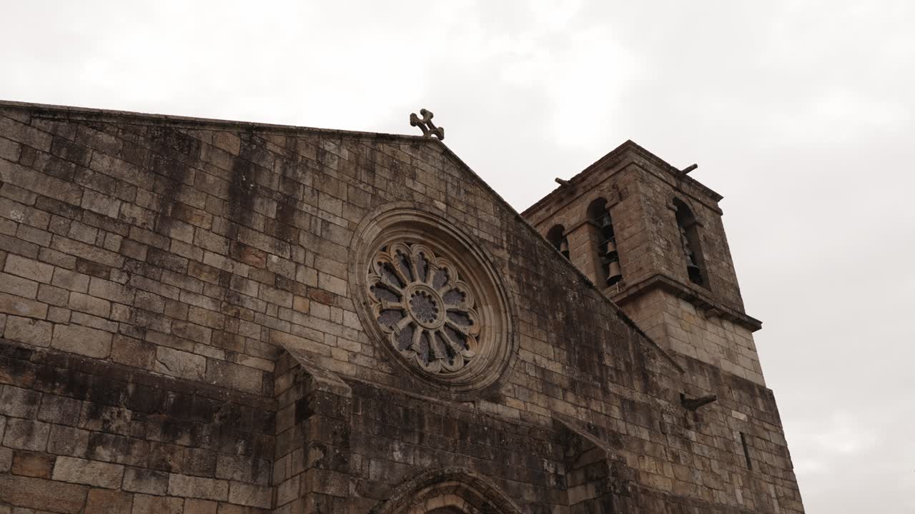 Historic stone façade and rose window of Matriz Church with bell tower in Barcelos Portugal