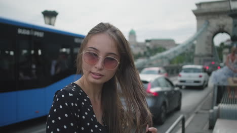 young woman on a city bridge