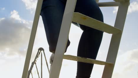 Low-section-of-disabled-woman-climbing-ladder-in-the-park-4k