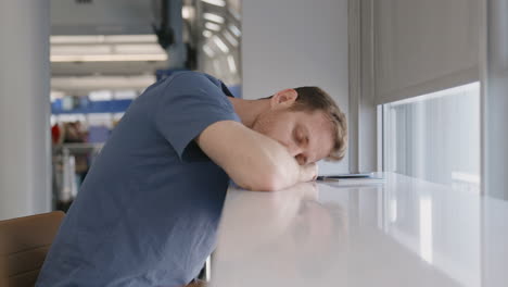 man-Sleeping-in-an-airport-while-waiting-for-his-flight