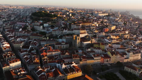 sunrise hitting hills of lisbon from the air