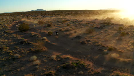 aerial view of young boys riding dirt bikes on a off road track in the mojave desert