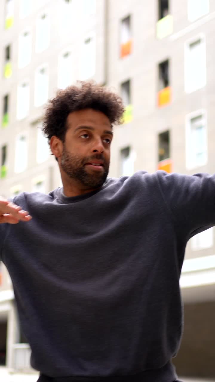 Man dancing in front of building