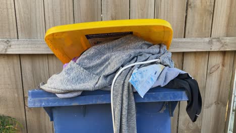 closeup of abandoned clothes in the trash bin