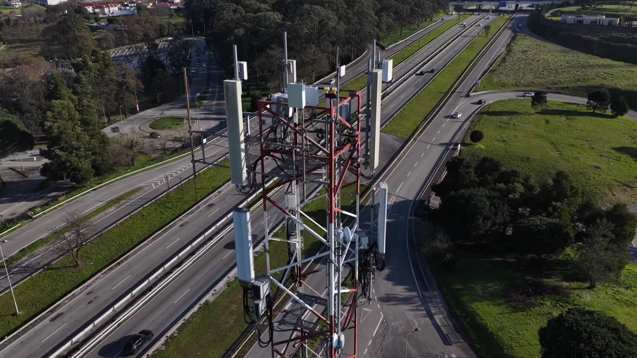 Close up shot of Mobile communications tecnhology tower near a highway. 5g and 6g antenna.