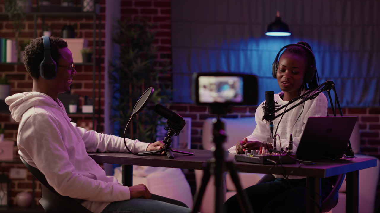 Content creator interviewing famous vlogger recording vlog using digital camera